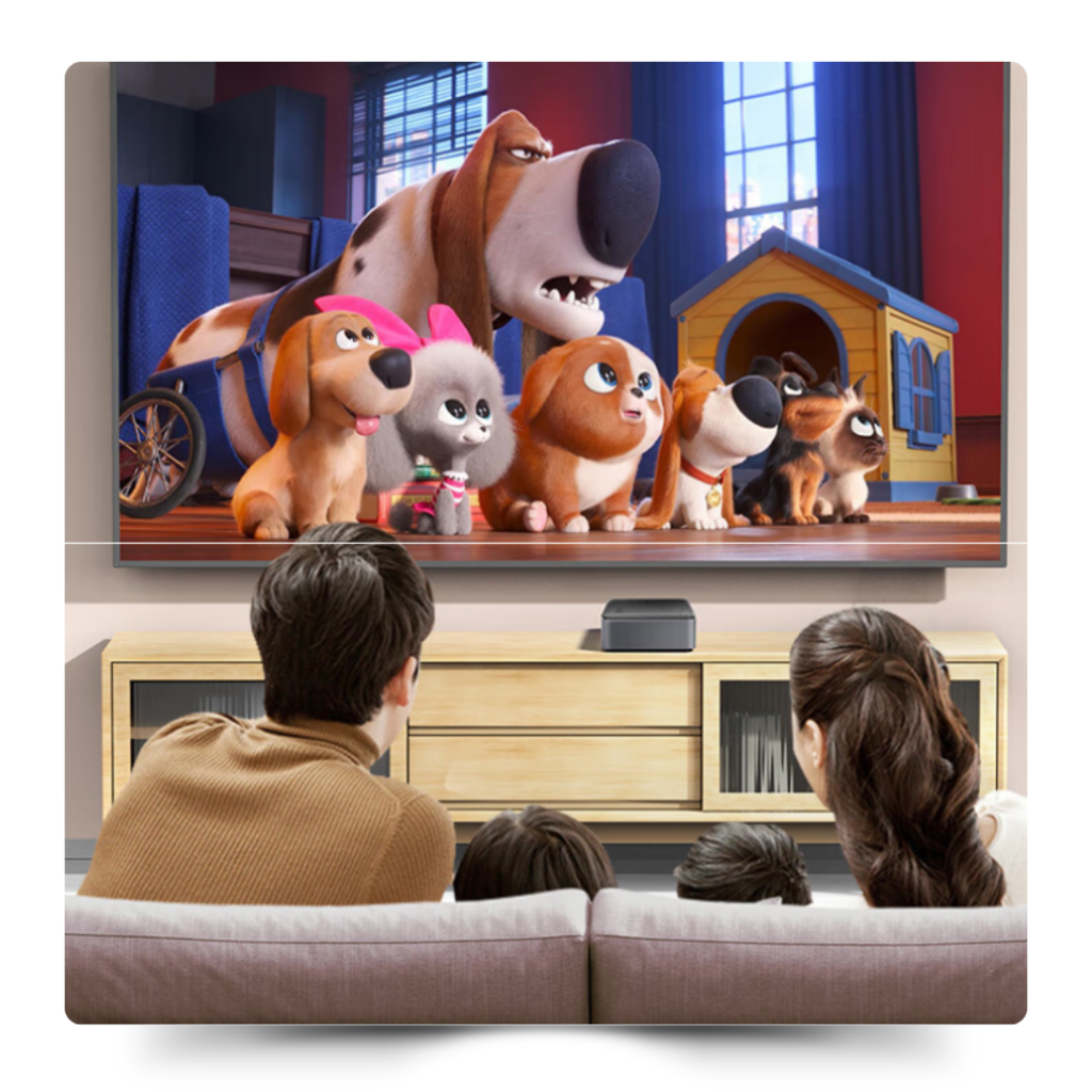 替代文字：一家四口坐在沙發上觀看電視，電視屏幕上播放著一部動畫影片，顯示出一個家庭娛樂中心的場景，中心桌上放置著一台智能設備。